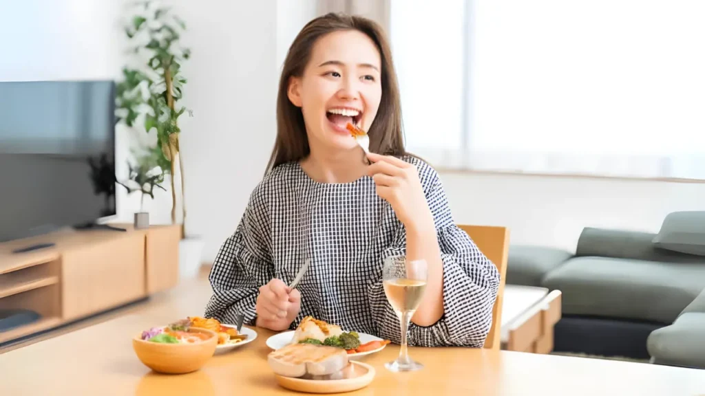 a woman happily eating a high fiber meal