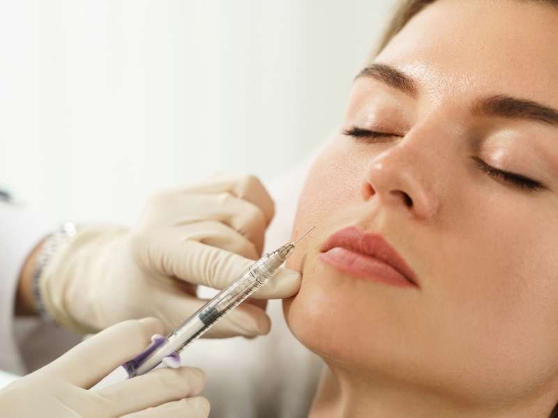 Aesthetic professional administering a facial filler injection for youthful skin