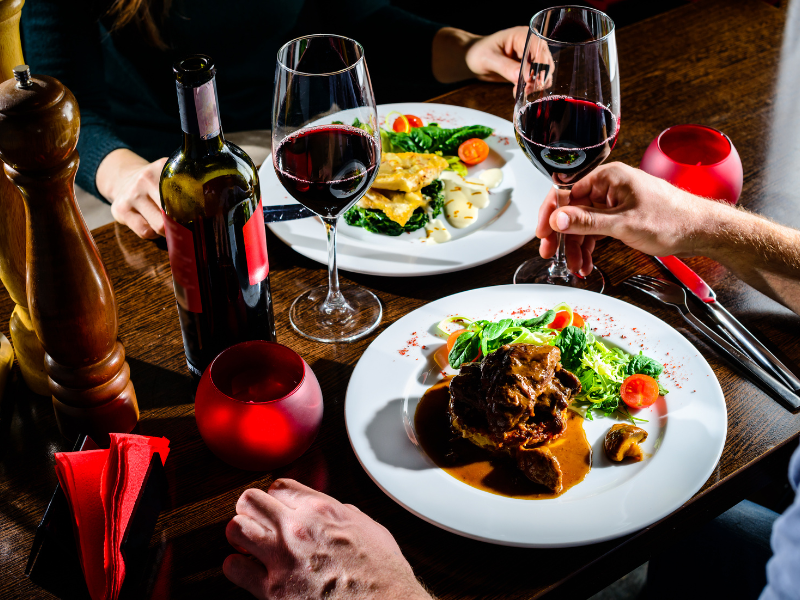 Elegant dinner setup with wine and delicious gourmet dishes