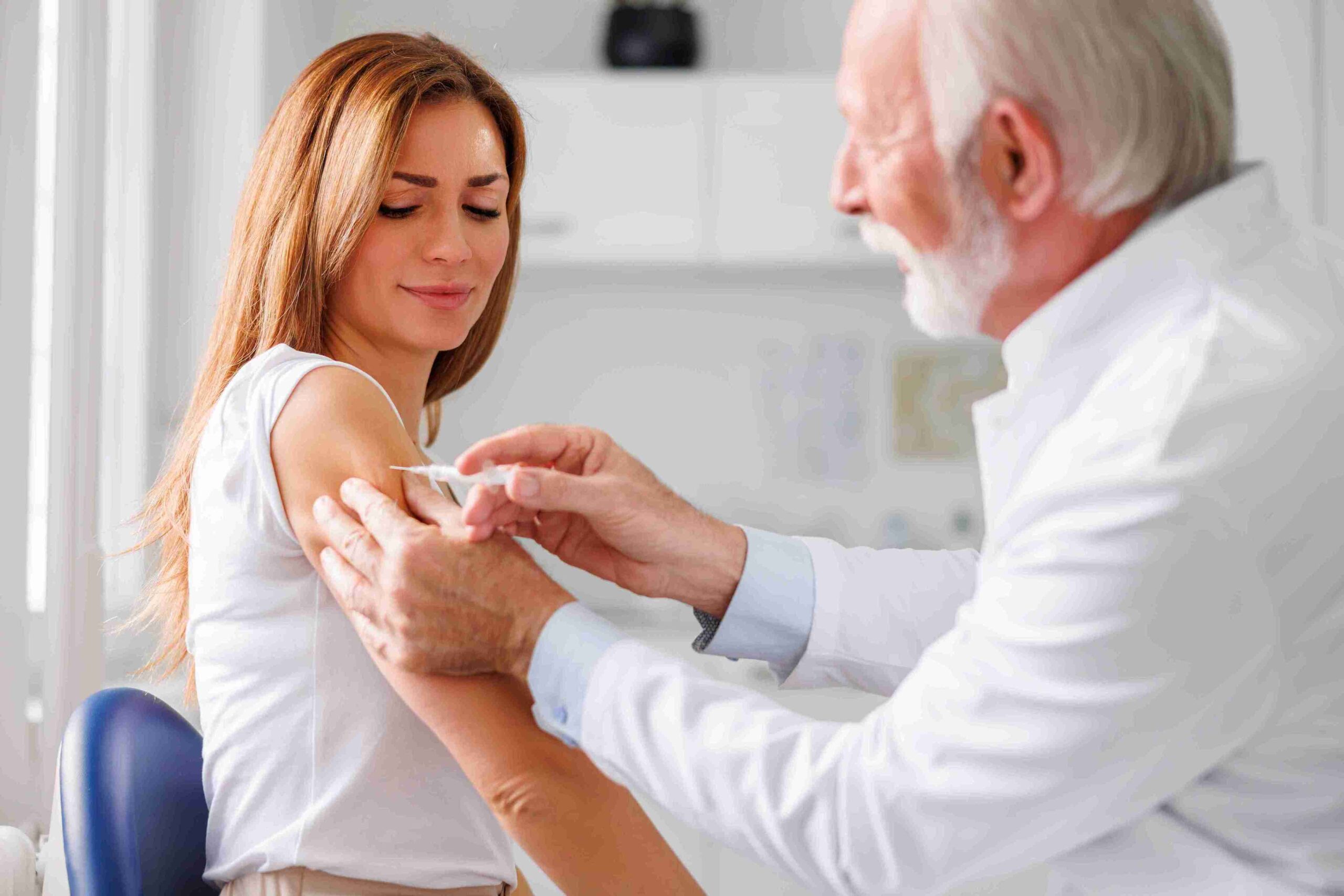 woman getting vaccinated with flu vaccine