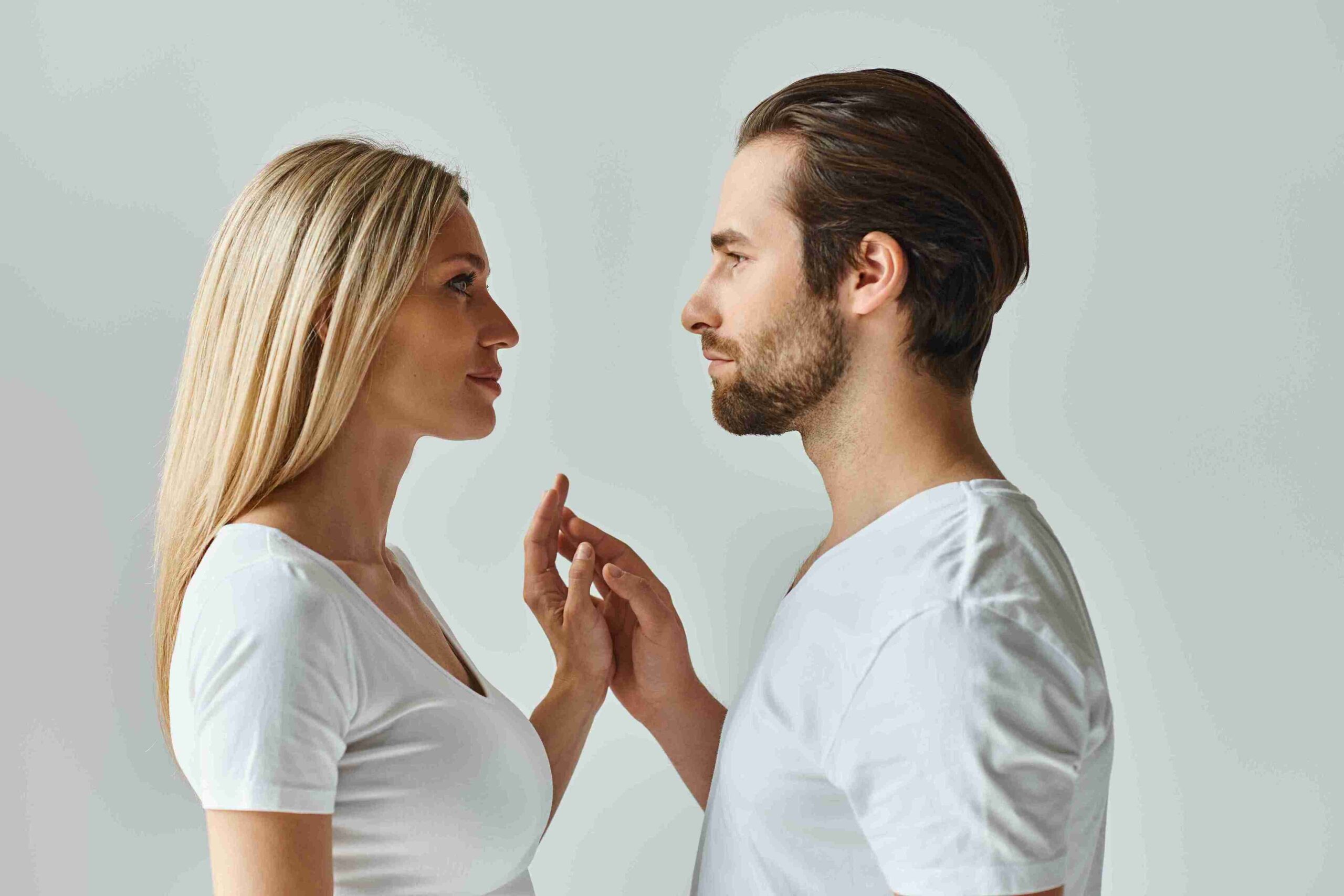 couple looking into each other's eyes and touching hands