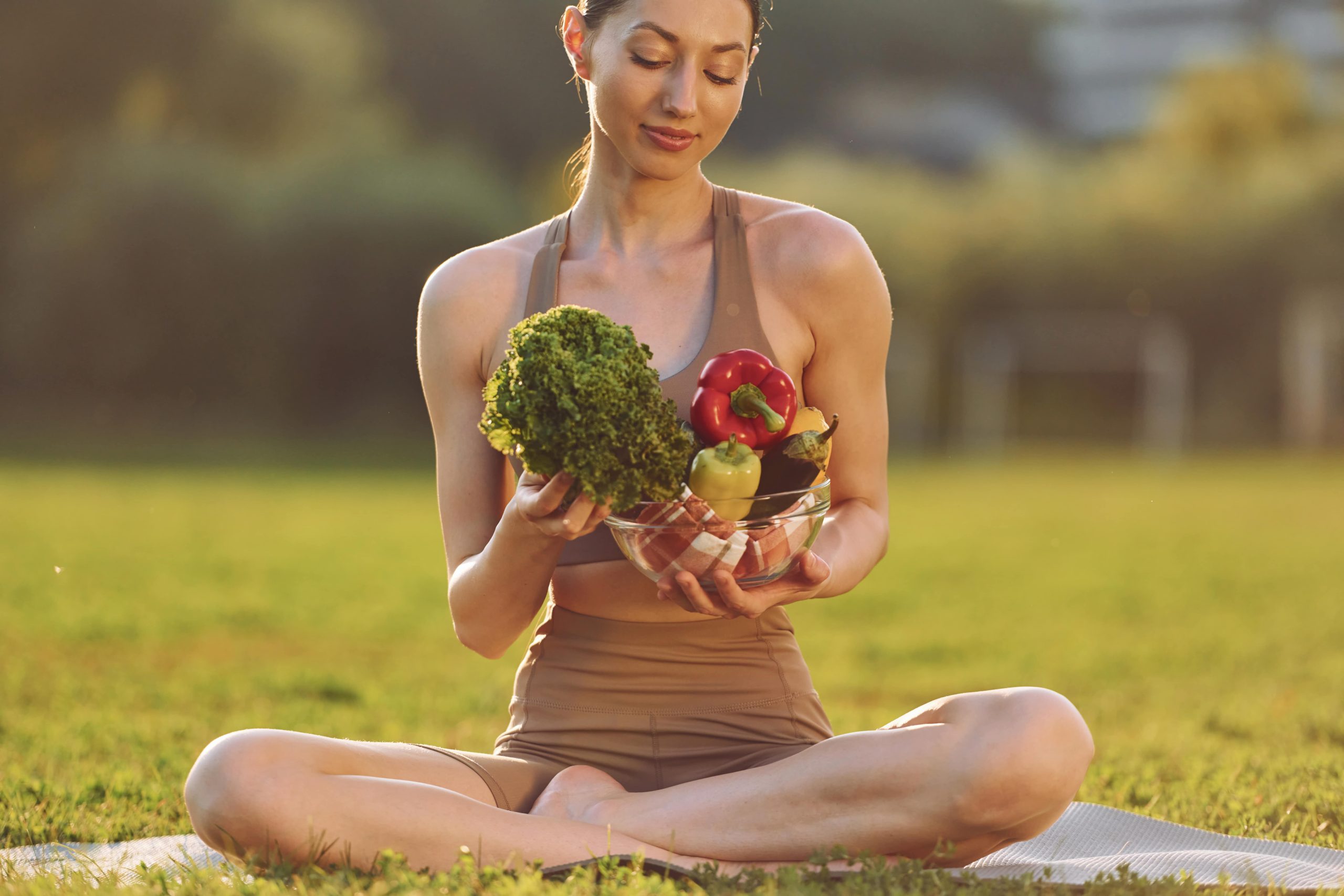 yogi woman looking at vegetables she's carrying