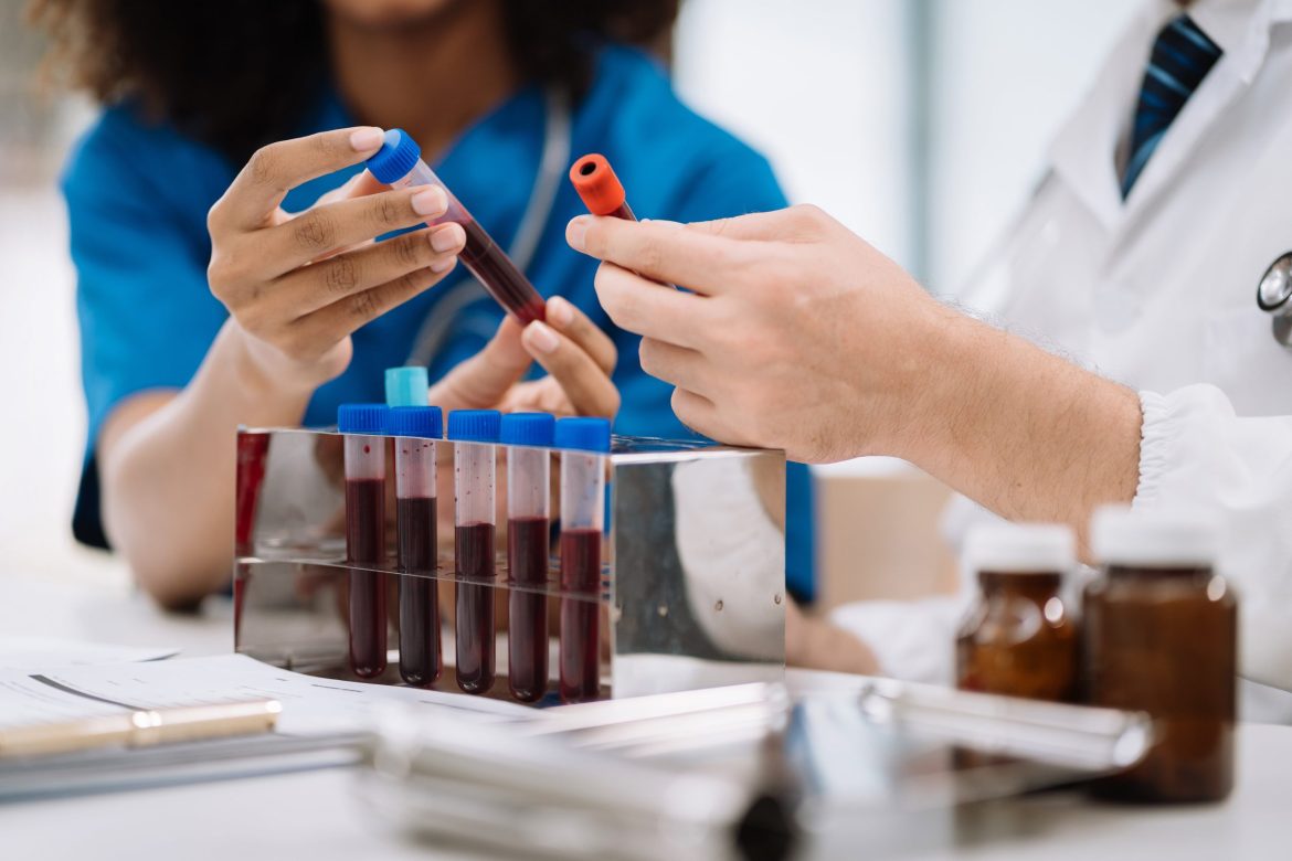 healthcare professionals looking at blood test specimens