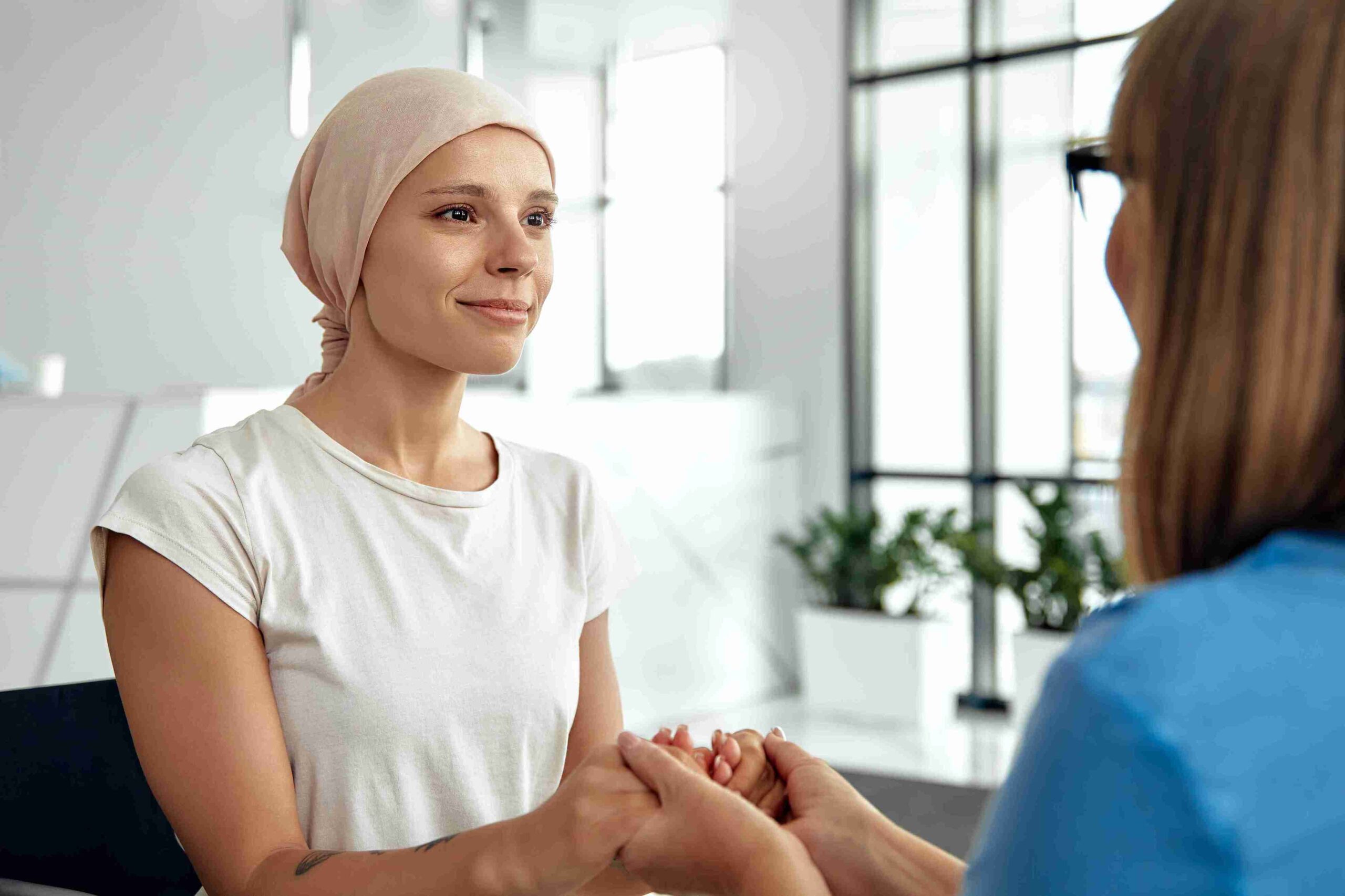 caregiver holding a cancer patient's hand
