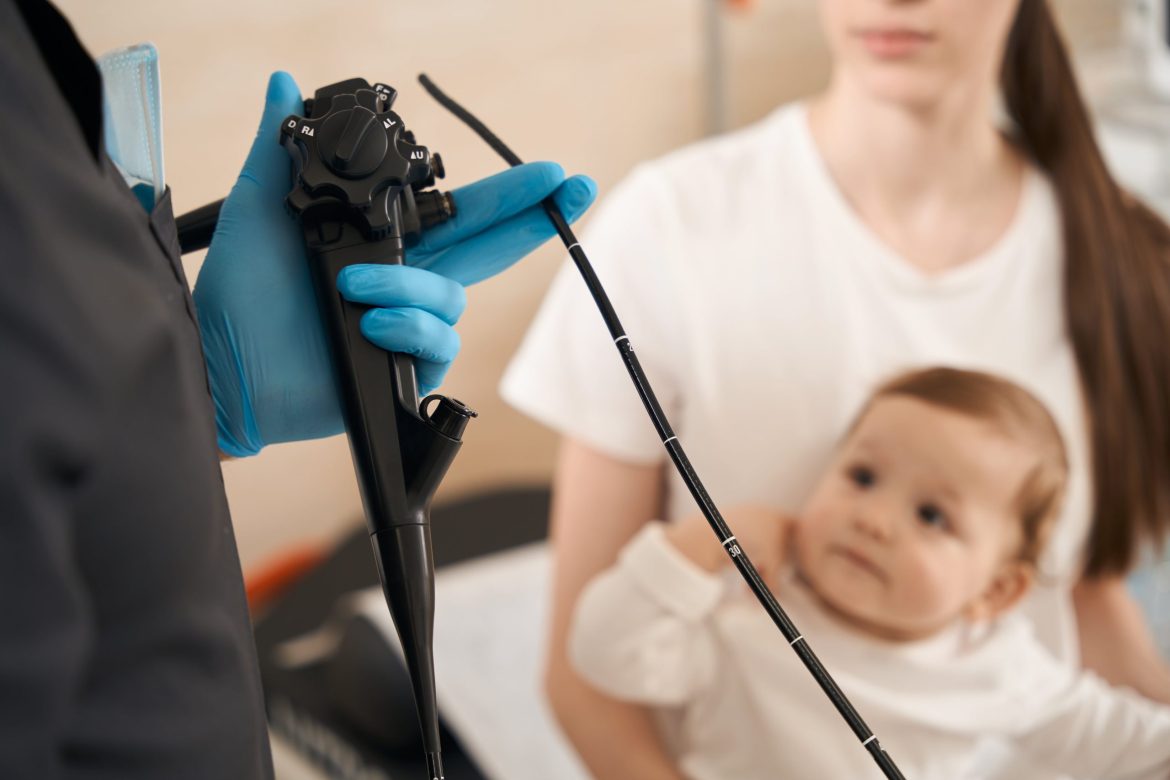 endoscopist preparing baby for endoscopy