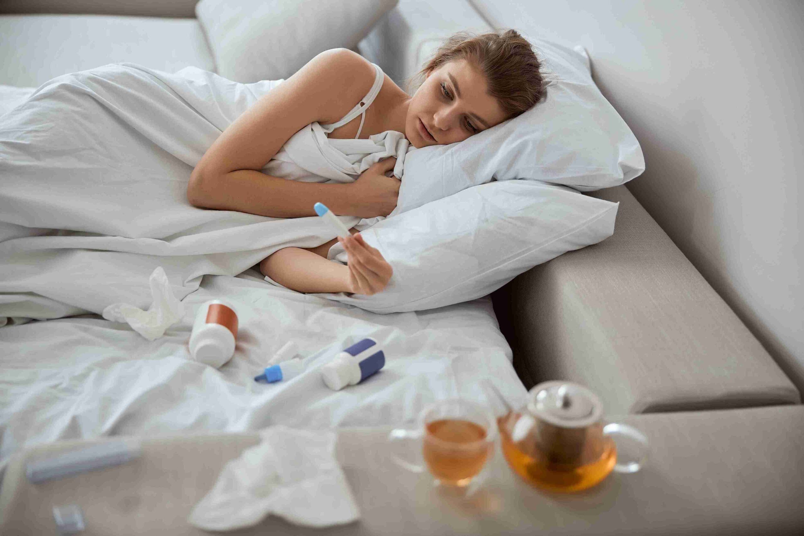 female sick and lying in bed