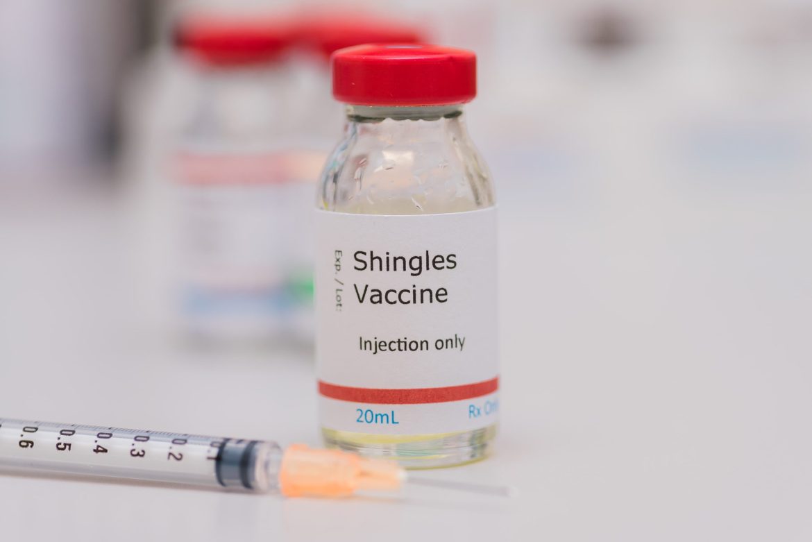 shingles vaccine with an injection needle next to it