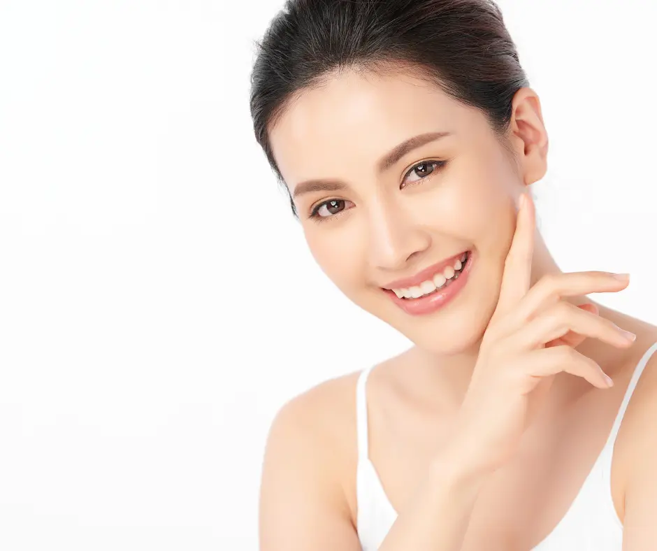 A young woman with a bright smile and clear skin, representing beauty and self-care