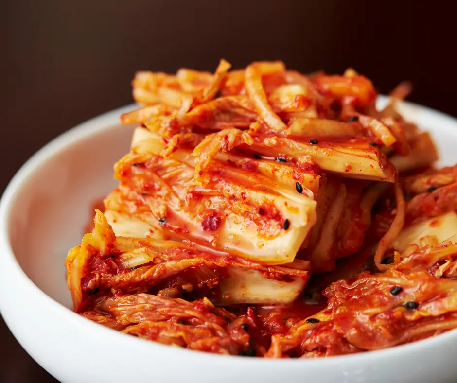 A close-up of a bowl filled with fresh, spicy kimchi, a traditional fermented Korean dish