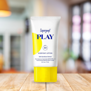 Supergoop! PLAY Everyday Lotion SPF 50 bottle on a table in a living room