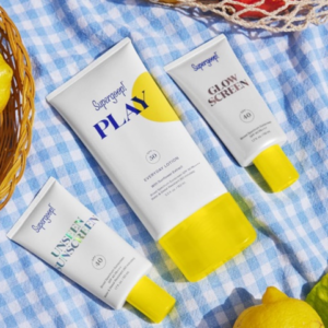 Supergoop! PLAY Everyday Lotion SPF 50 on a blanket along with supergoop unsented sunscreen and slow sunscreen