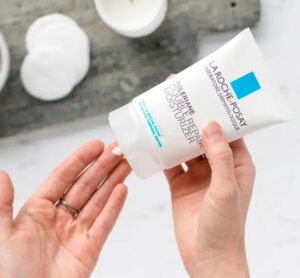 La Roche-Posay Toleriane Double Repair being used by a hand model on a lovely bathroom background