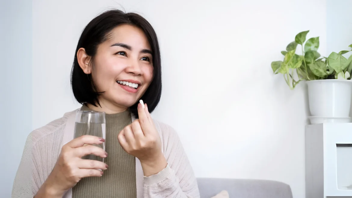 a beautiful and happy woman about to drink glutathione