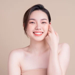 a beautiful asian woman touching her face