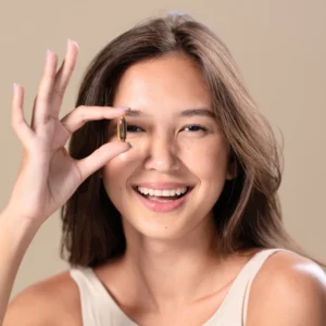 a beautiful asian woman holding a tablet of glutathione