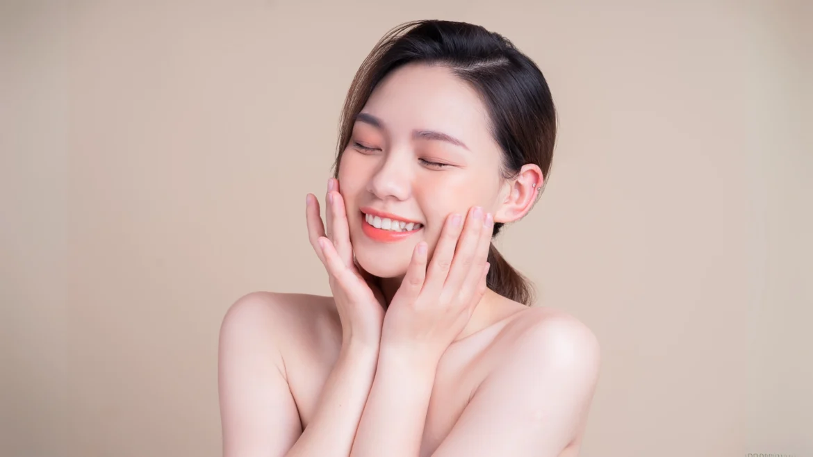 a beautiful asian woman looking happy at the results of her glutathione treatment