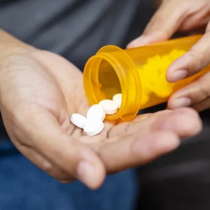 a bottled on glutathione pills - Allure Wellness glutathione pills being taken from the bottle