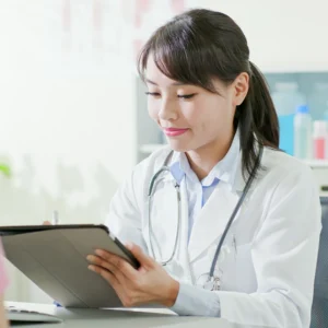 a doctor in her office holding a tablet