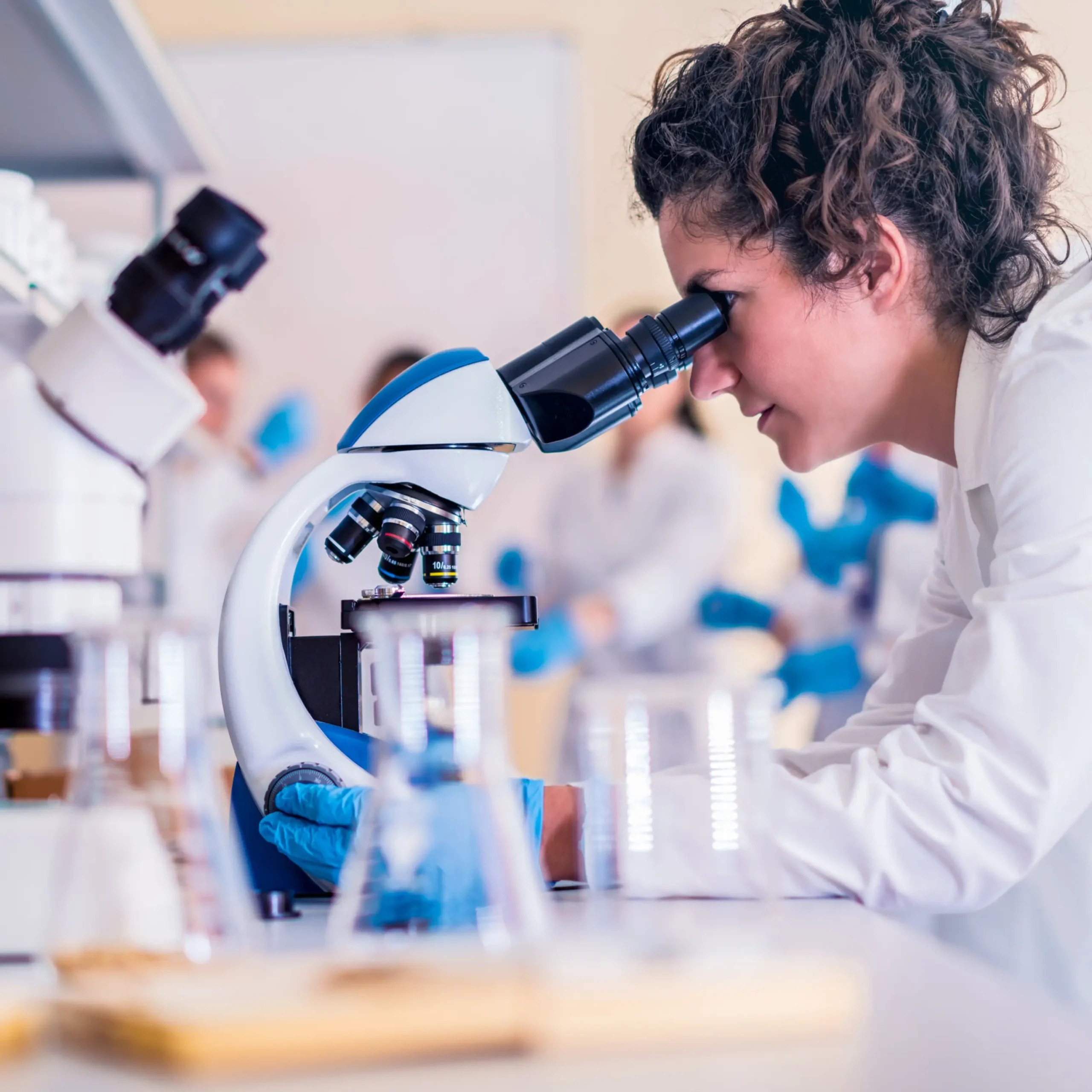 researchers studying glutathione and collagen under a microscope - Allure Wellness researchers studying glutathione and collagen under a microscope