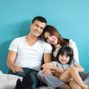 a family happily cuddling together on a couch
