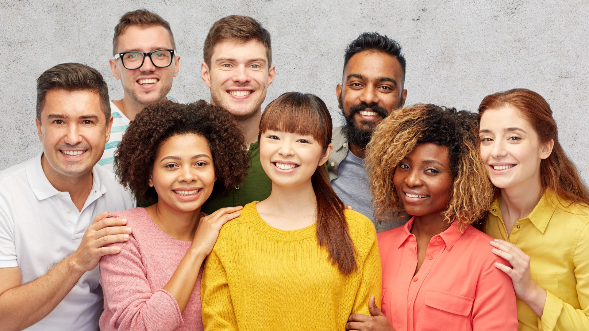 a group of smiling people of various ages