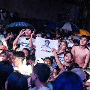 Supporters cheering in the rain